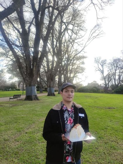 David in a Melbourne park holding a birthday cake