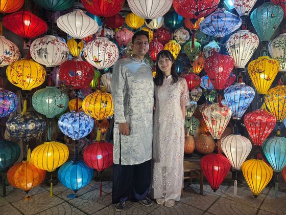 David and his partner in ao dai under Hoi An lanterns